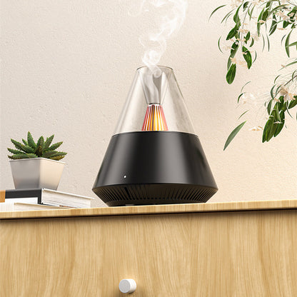 Umidificador de ar Sillencia VolcanoMist em preto liberando névoa com luz de chama interna em uma mesa.
