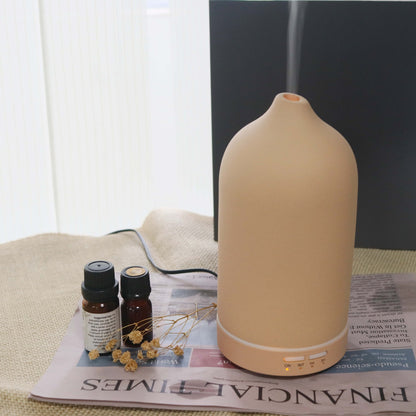Umidificador de ar Sillencia ZenMist Ceramic em rosa com névoa suave e óleos essenciais ao lado